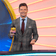 Ryan Seacrest holding Passion Fruit Tangerine kombucha